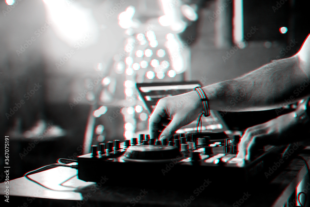 hands DJ mixing and playing music on a professional controller mixer hands DJ mixing and playing music on a professional controller mixer