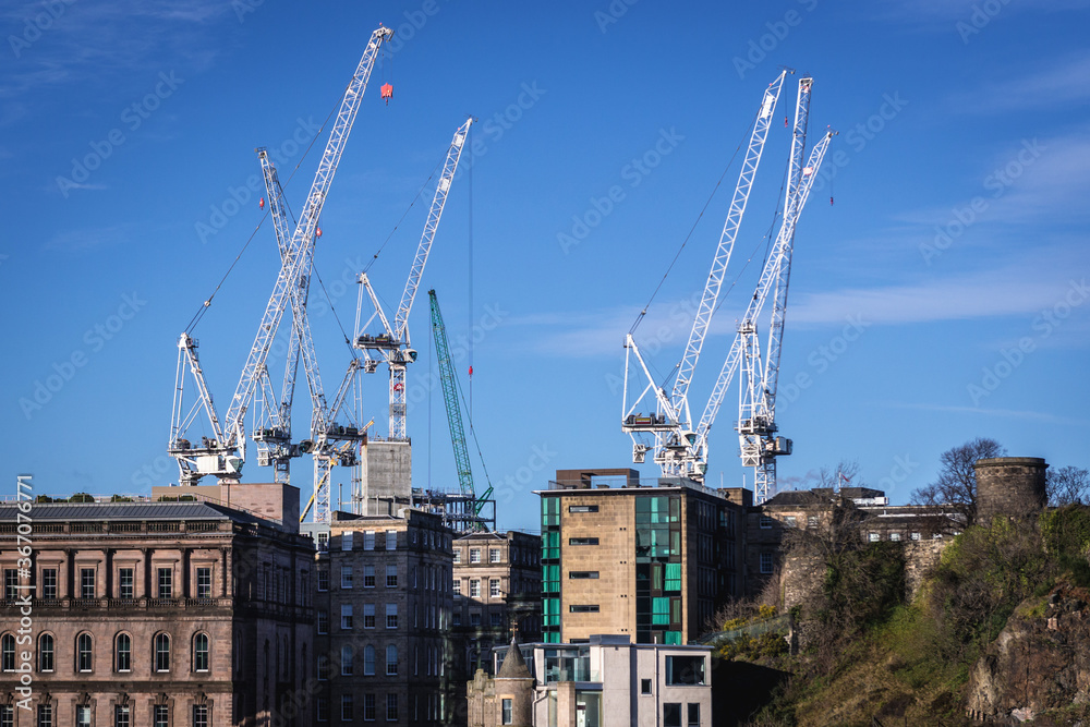 Cranes on construction site, view from Old Town of Edinburgh city, Scotland, UK