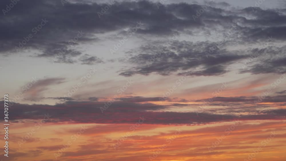 Clouds Float across the Evening Blue-Orange Sky after Sunset. Time Lapse of 4k Clouds at Sunset. The Multi-Colored Sky. Clouds Float across the Evening Blue-Orange Sky after Sunset. Time Lapse of 4k Clouds at Sunset. The Multi-Colored Sky.
