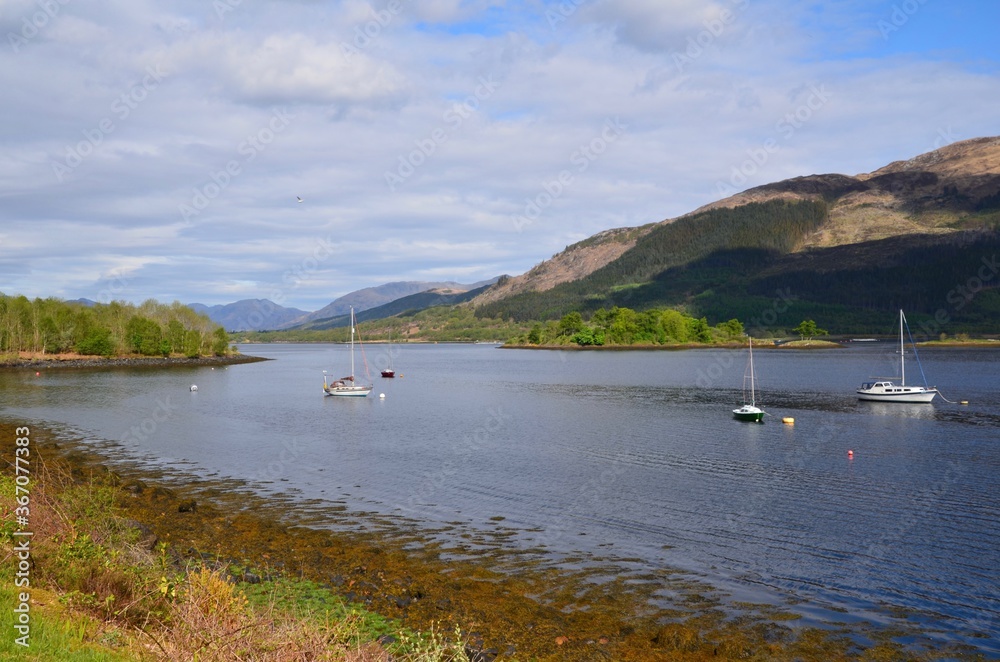 River Coe, Glencoe, Scottish Highlands with sailing boats and mountains in background