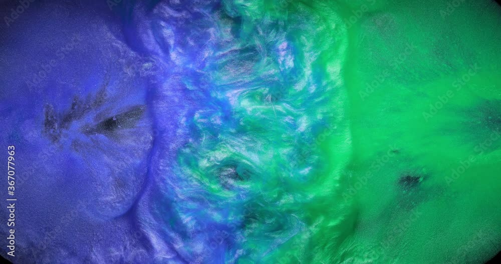 Teal green and light blue fluid pearl inks are melting into each other creating beautiful waves of mixed swirling clouds. Slow motion of colorful paints. Abstract art background, creative concept Teal green and light blue fluid pearl inks are melting into each other creating beautiful waves of mixed swirling clouds. Slow motion of colorful paints. Abstract art background, creative concept