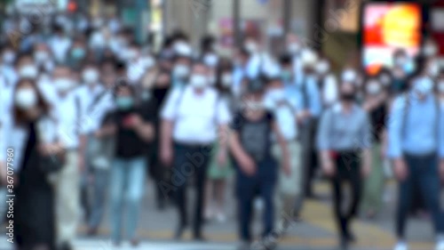Wallpaper Mural TOKYO, JAPAN - JUL 2020 : Crowd of people at the street near Shinjuku station in rush hour. Commuters wearing surgical mask to protect from Coronavirus (COVID-19) in hot summer. Blurred slow motion. Torontodigital.ca