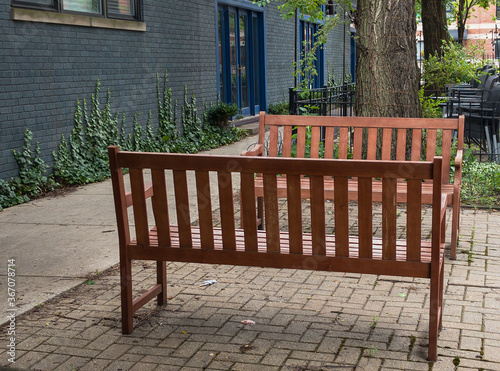 two empty wooden benches facing each other outdoors