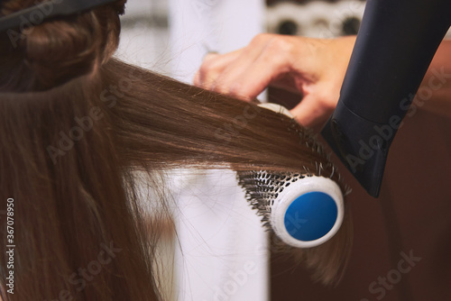 hair drying with a hair dryer in a barbershop. Master universal dry and comb the hair hair