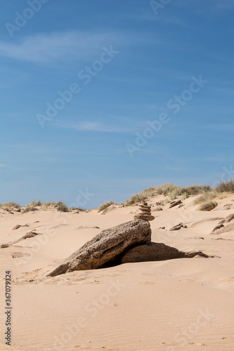 Stack Of Pebble On Sandy Beach