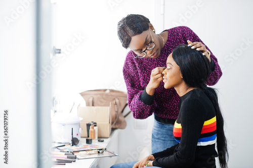 Wallpaper Mural African American woman applying make-up by make-up artist at beauty saloon. Torontodigital.ca