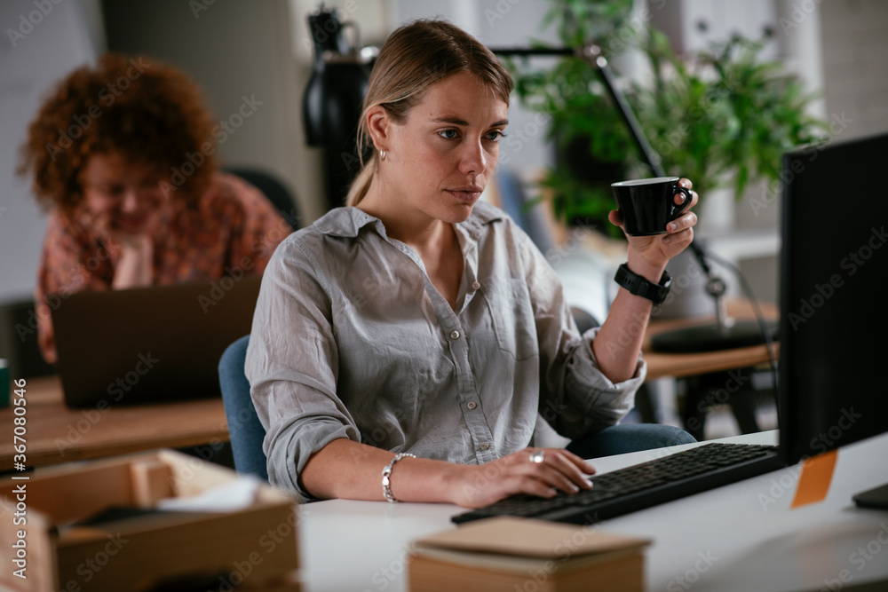 Young businesswoman drinking coffee in her office
Young businesswoman drinking coffee in her office