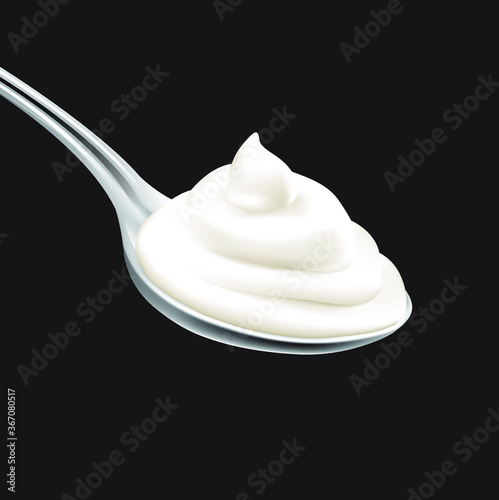 Spoon of cream on black background