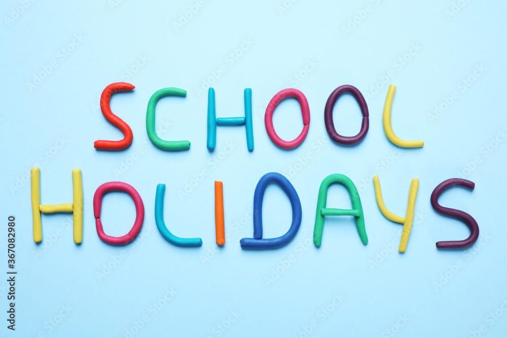 Phrase School Holidays made of modeling clay on light blue background, top view Phrase School Holidays made of modeling clay on light blue background, top view