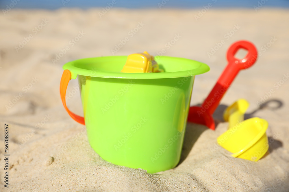 Child plastic toys on sandy beach at sunny day Child plastic toys on sandy beach at sunny day