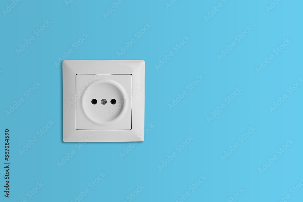 Light blue wall with power socket, space for text. Electrical supply Light blue wall with power socket, space for text. Electrical supply