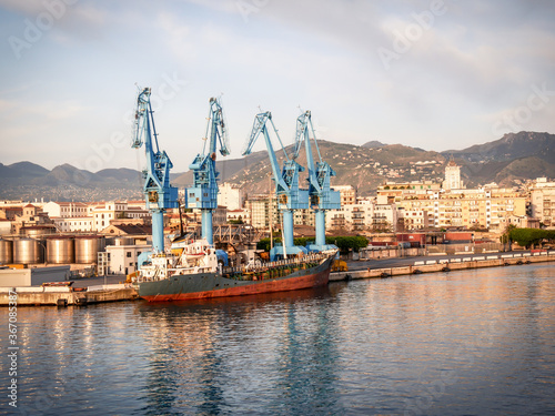 cargo ship moored at the quay of the port of Palermo on a sunny spring morning