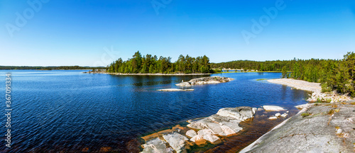 Rocky coast of Koyonsaari (southern part) overlooking the island of Erosaari. Panorama. Ladoga lake. Karelia. Russia