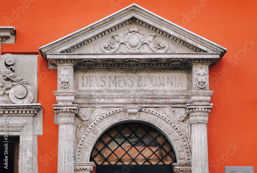 Orange and white facade of an old portal of a house with aphorisms, Hepner's townhouse. Inscription DEUS MEUS ET OMNIA means God is my all. Renaissance architecture in Lviv, Ukraine. photo