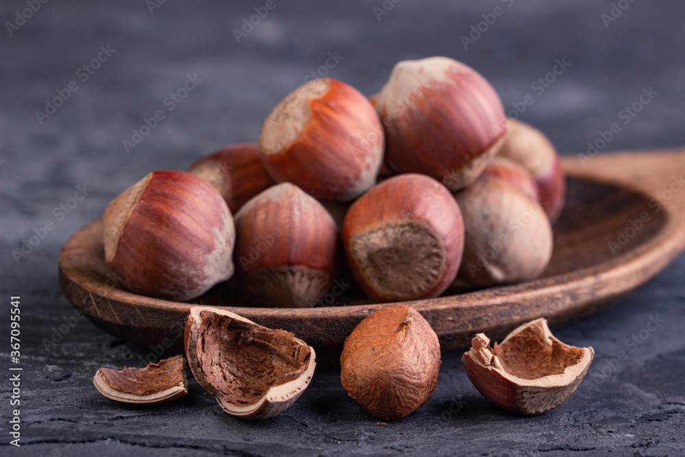 Hazelnuts in a spoon and one broken nut Hazelnuts in a spoon and one broken nut