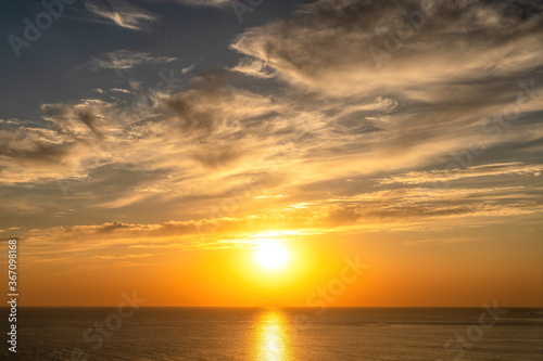 Beautiful fiery sunset sky on the beach. Composition of nature view of the sunset sea and the beach  a Copy of the space. The concept of calm  silence and unity with nature