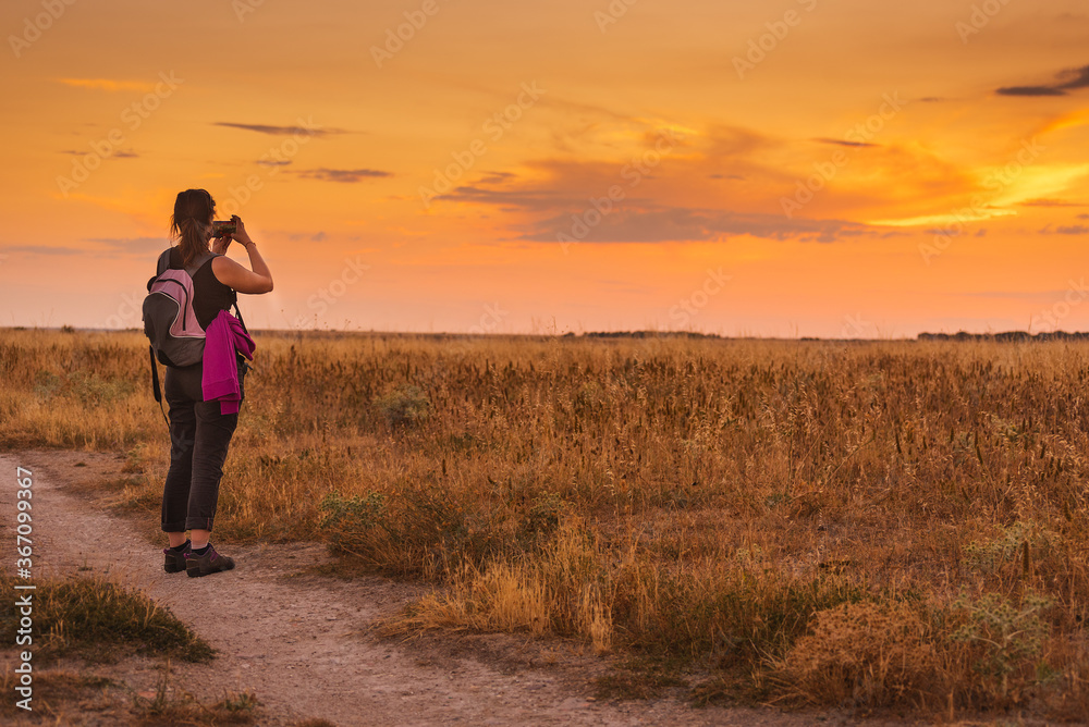 hiker taking a photo with her mobile