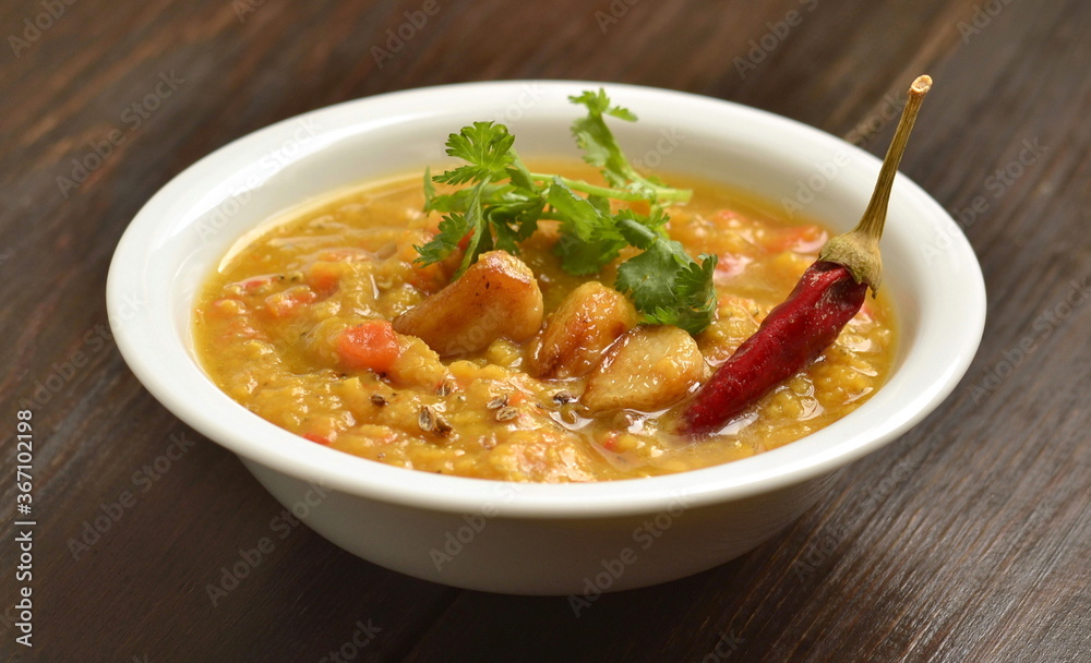 Dal, red lentil soup with turmeric, garlic, chili and cilantro. Indian food.