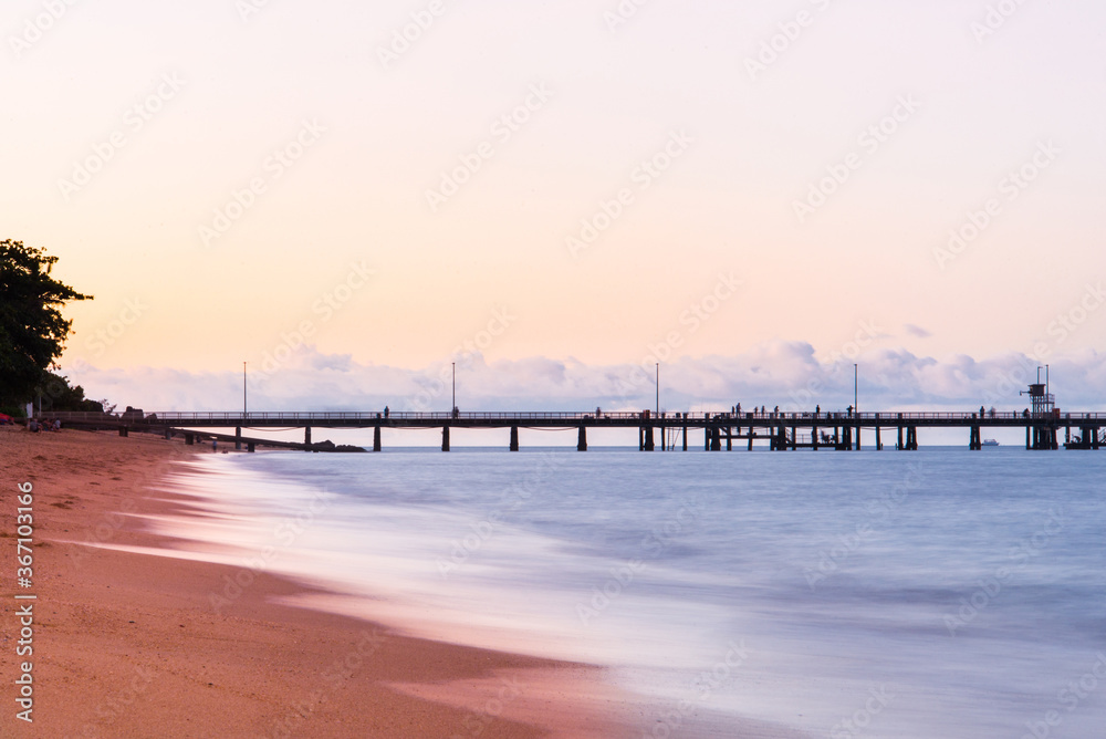 Pier over tropical beach at sunrise