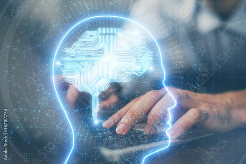 Businessman with computer background with brain theme hologram. Concept of brainstorm. Multi exposure. © peshkova