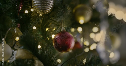 Christmas Toy On A Christmas Tree Against A Garland In The Blur