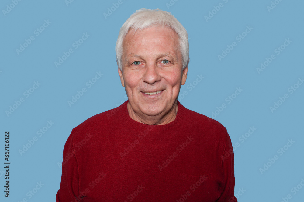 Senior handsome man with grey hair at home standing and smiling against blue studio. Human emotions concept Senior handsome man with grey hair at home standing and smiling against blue studio. Human emotions concept