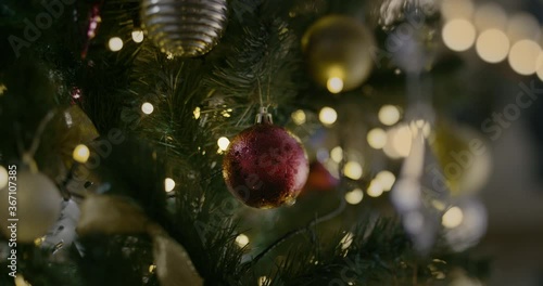 Christmas Toy On A Christmas Tree Against A Garland In The Blur