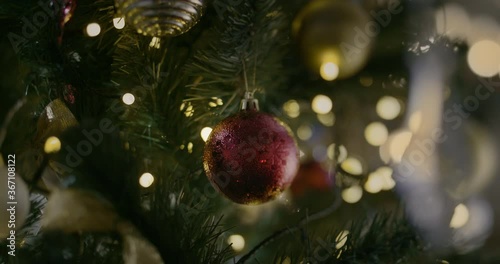 Christmas Toy On A Christmas Tree Against A Garland In The Blur