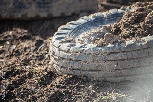 Old tires from the car are lying on the street.