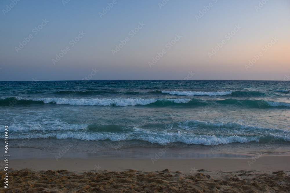 The blue hour on the beach, sea, waves, wonderful colors in the sky