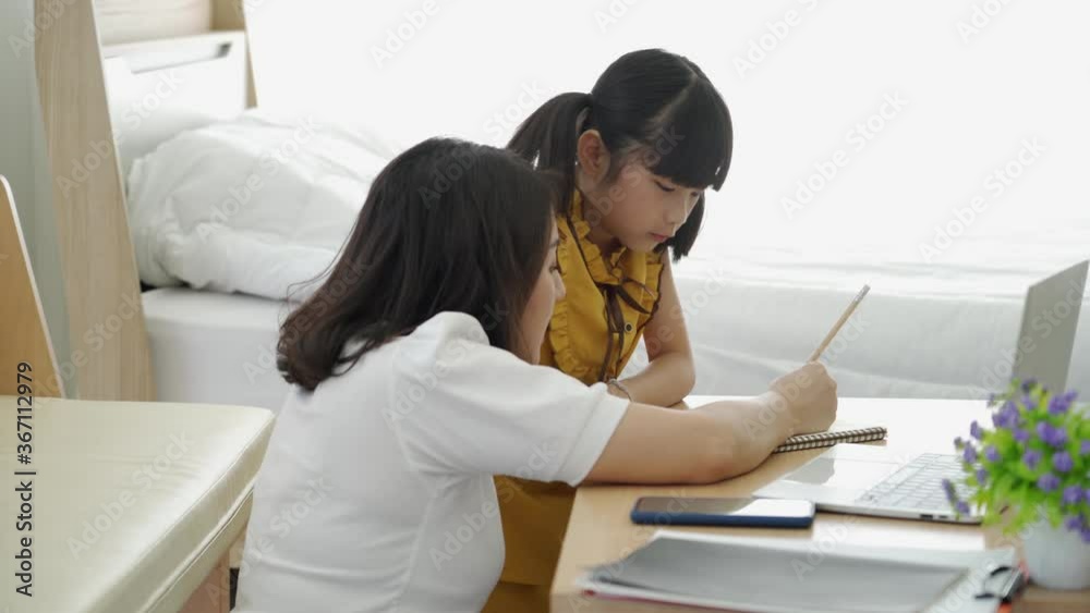 Asian mom teaching daughter learning with computer internet online at home, New normal online study education concept Asian mom teaching daughter learning with computer internet online at home, New normal online study education concept