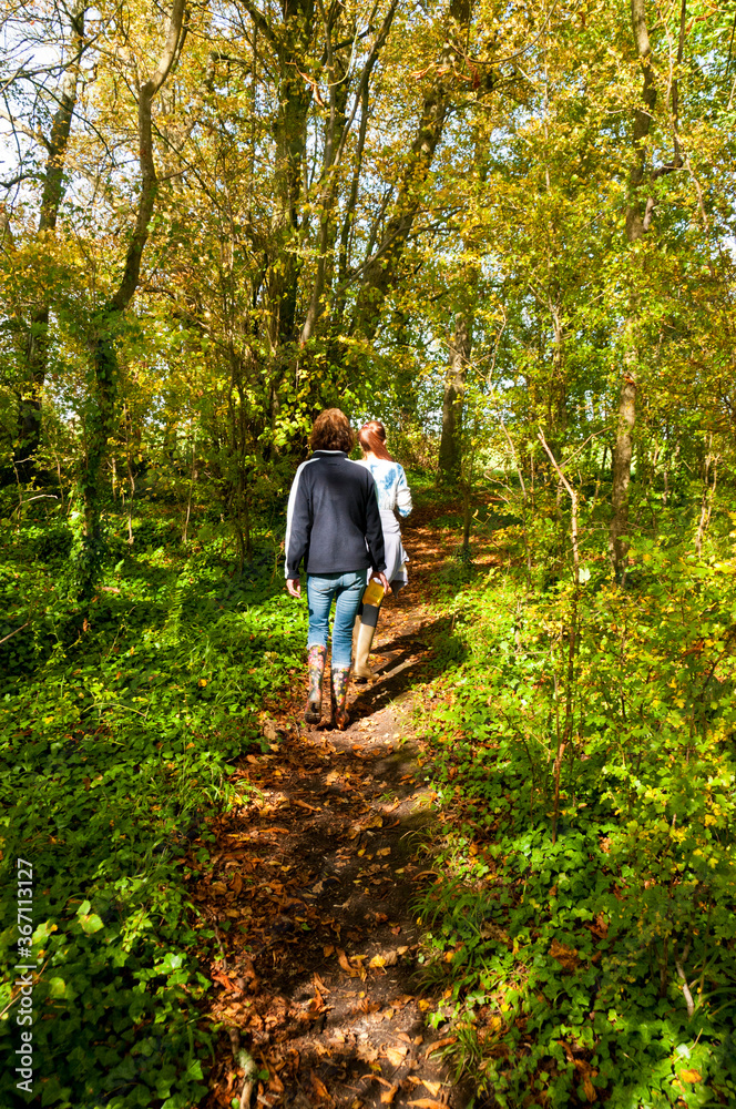Mother and daughter walking in the woods near Wedmore, Somerset, England Mother and daughter walking in the woods near Wedmore, Somerset, England