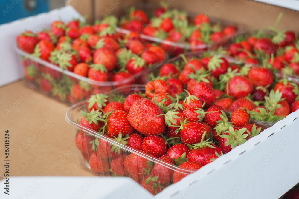 Strawberries are sold at the farmers ' market. Fresh juicy strawberry close-up. Selective and soft focus. Season of strawberries and other berries.