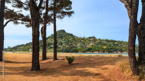 Mount Paku and part of the coastal holiday town of Tairua, New Zealand, seen from across the harbor at Pauanui