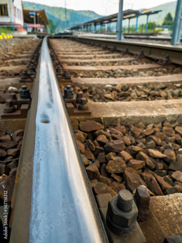 Close-up detail with a railroad track. Selective focus. Busteni train station in Romania. © Cristi