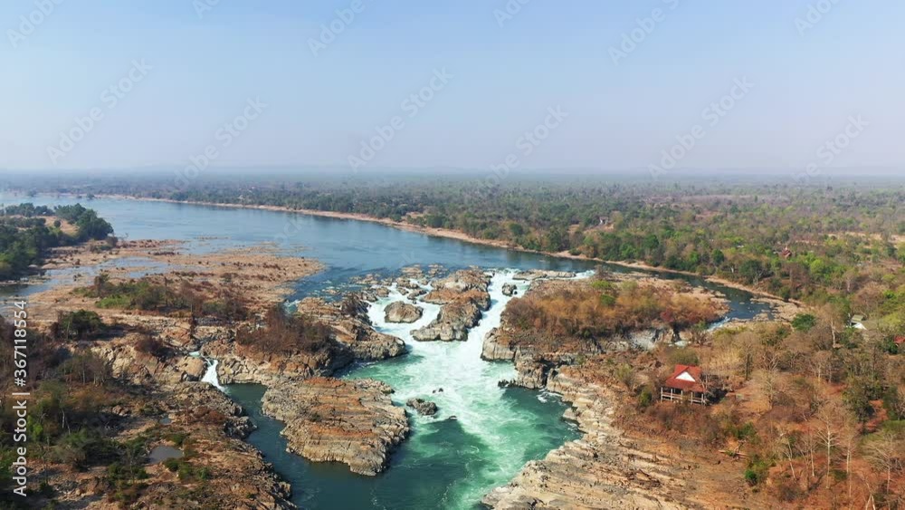 The panoramic view of Khone Falls on the Mekong in Asia, Laos, Champassak, 4000 islands, Don Det, on a sunny day. The panoramic view of Khone Falls on the Mekong in Asia, Laos, Champassak, 4000 islands, Don Det, on a sunny day.
