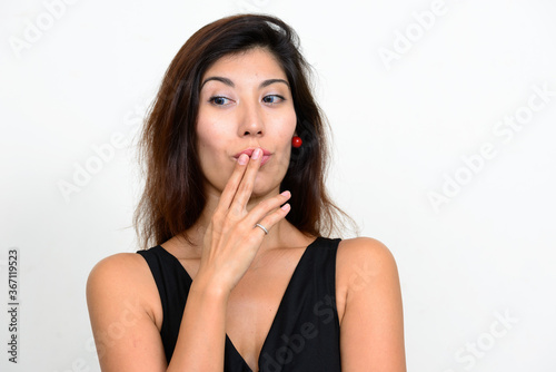 Portrait of young beautiful woman with finger on lips