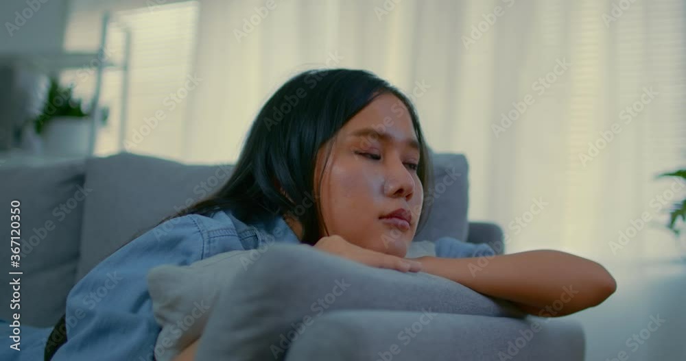 Slow motion short of unhappy lonely depressed woman at home, she is laying down on the couch, depression concept Slow motion short of unhappy lonely depressed woman at home, she is laying down on the couch, depression concept
