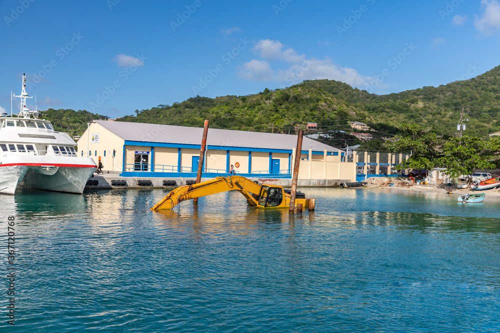 Dredging, pontoon excavator sunk in harbor in Carriacou, Grenada