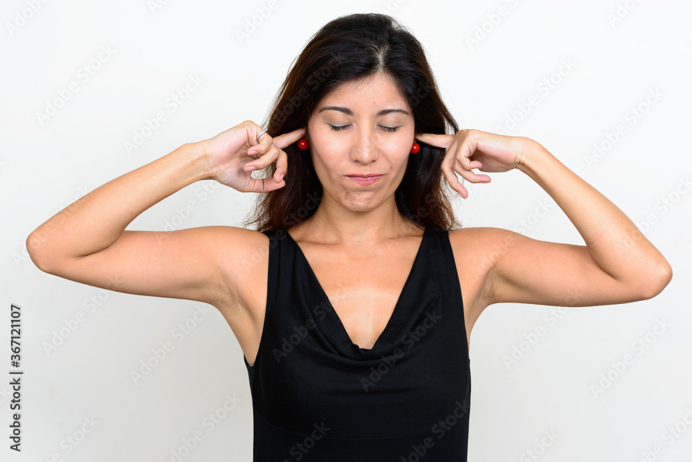 Portrait of stressed young woman covering ears Portrait of stressed young woman covering ears