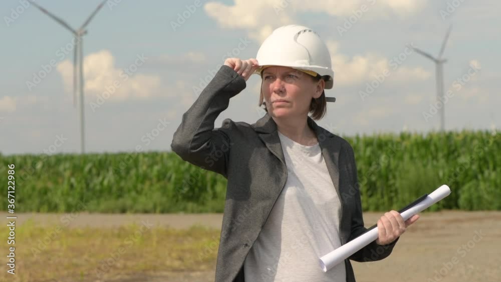 Portrait of female engineer on modern wind turbine farm Portrait of female engineer on modern wind turbine farm