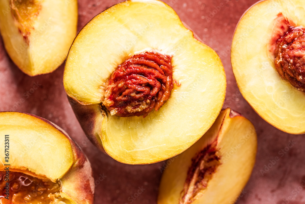 Fresh and juicy peaches halved and sliced. Close-up view. Fresh and juicy peaches halved and sliced. Close-up view.