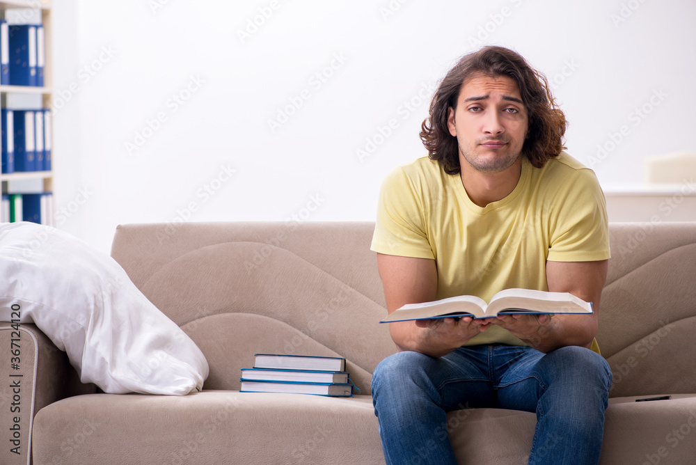 Young male student preparing for exams at home Young male student preparing for exams at home