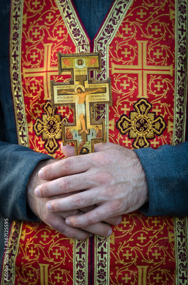 Big orthodox cross in the hands of orthodox priest