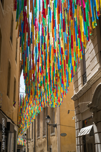 Closeup of colorful piece of plastic ribbon in the street for shadow by summer photo