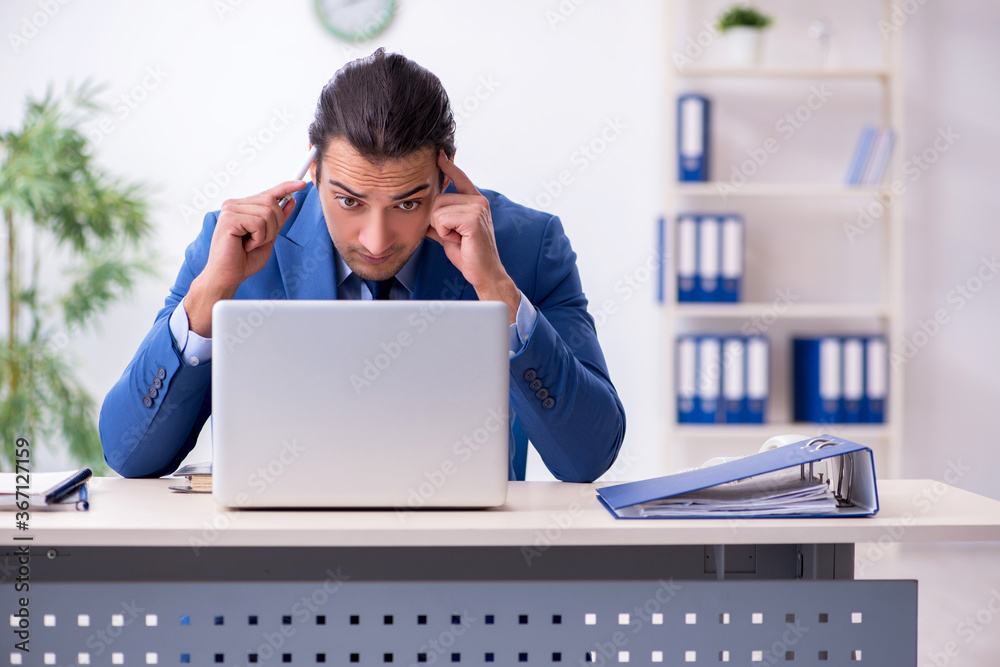 Young male employee in the office Young male employee in the office