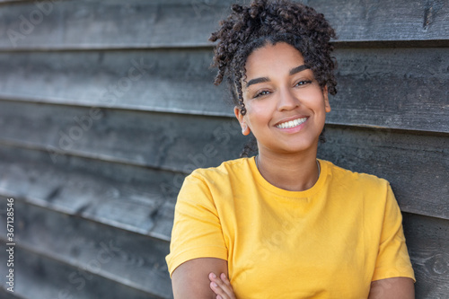 Girl teenager teen female young African American woman outside smiling with perfect teeth