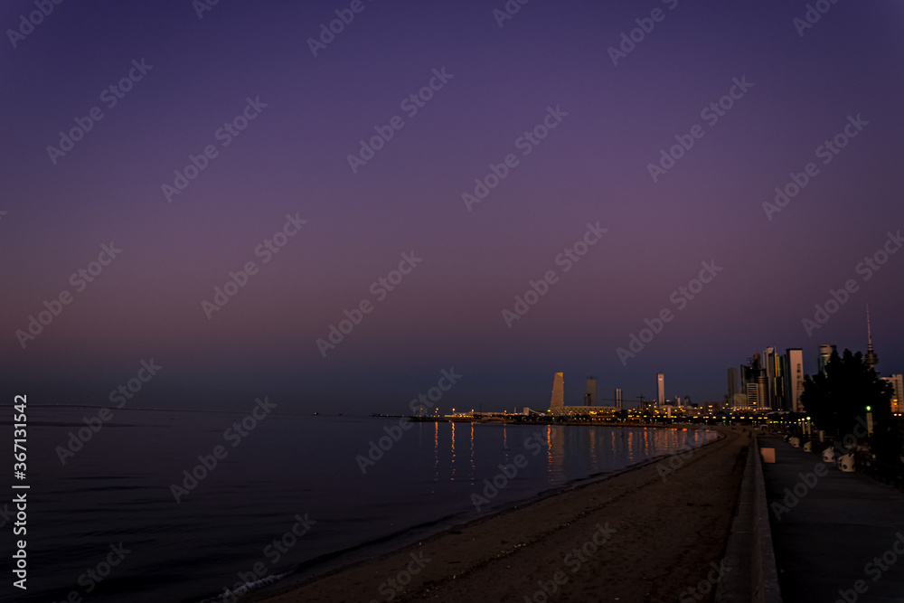 Beautiful landscape of Shuwaikh beach in city of Kuwait during while people are enjoying outside