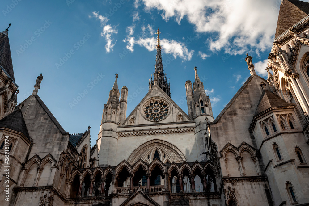 Victorian architectural landmarks, British judiciary and criminal trial concept with photograph of the royal courts of justice is London, UK