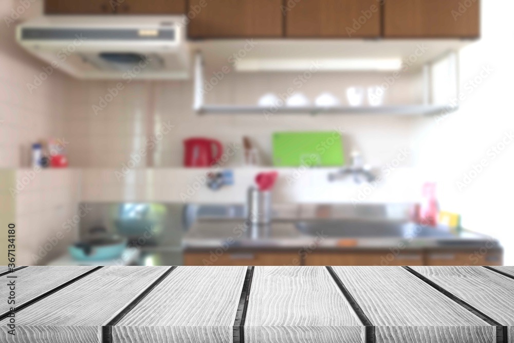 White wooden table and small kitchen corner blurred background White wooden table and small kitchen corner blurred background